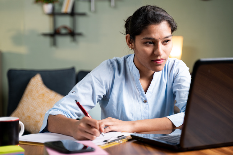 young woman at desk with laptop