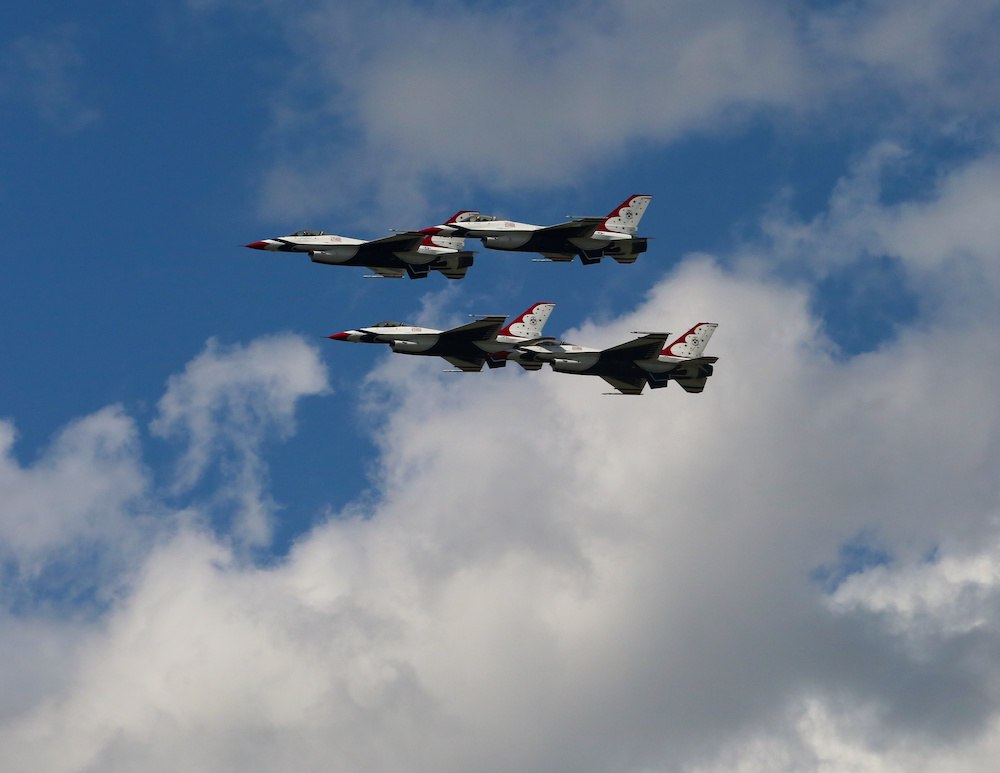 Air Force Thunderbird jets flying in close formation against blue sky