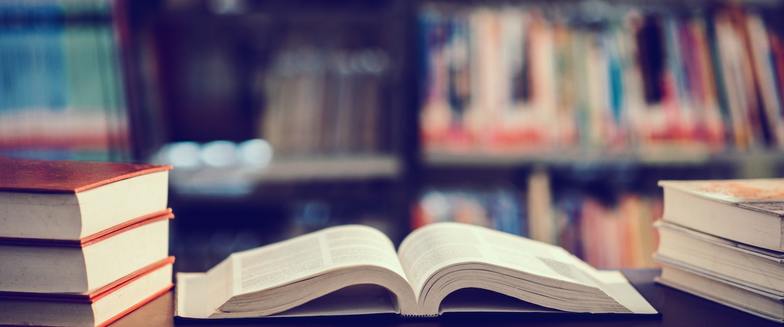 open book on shelf with other books