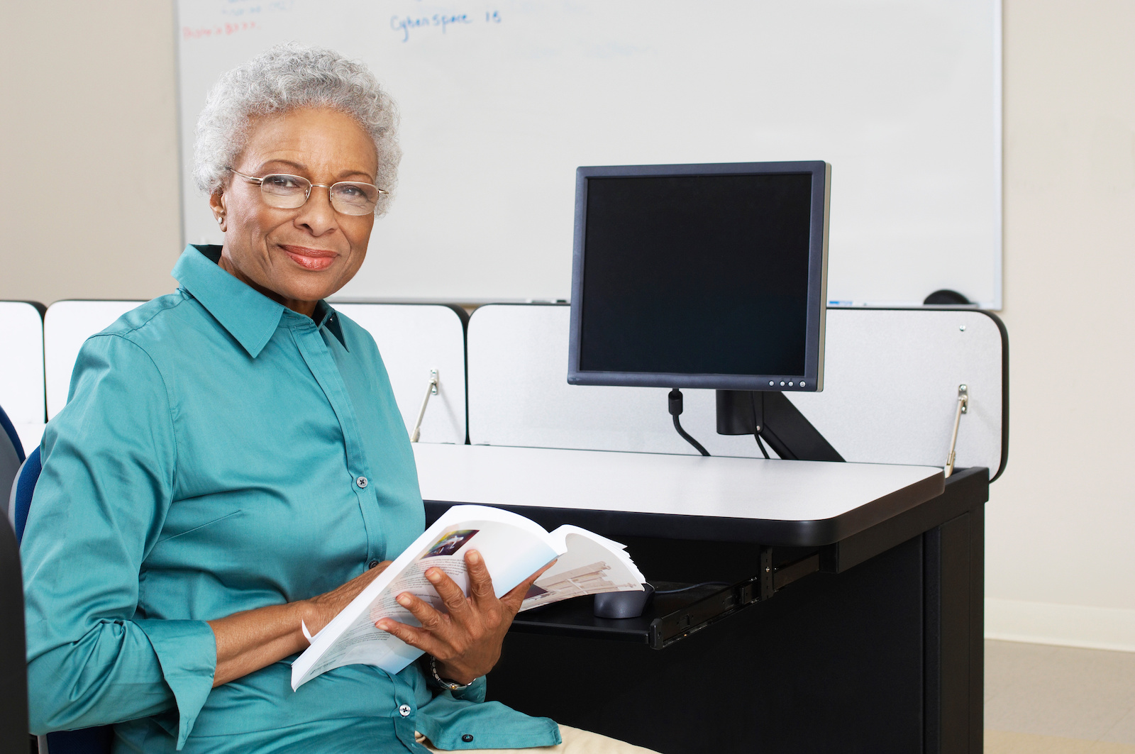 grey-haired woman at computer desk